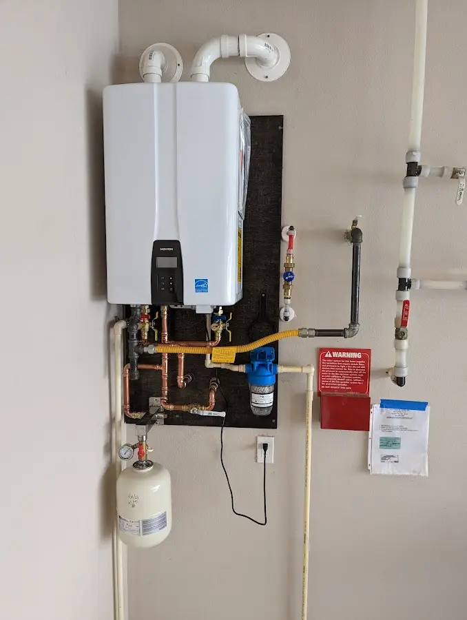 Professional plumber installing copper piping in a Wilder home